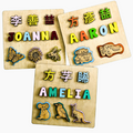 Children's name puzzle with dinosaurs and trucks, for bilingual families - The Charred Plank